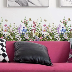 Macro detail of vibrant flower and butterfly wall stickers on a clean white living room wall