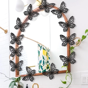 Detalle de 12 pegatinas de pared de mariposas 3D caladas con purpurina negra en madera