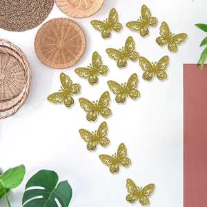 Detalle de 12 mariposas decorativas 3D doradas con purpurina y alas caladas talladas