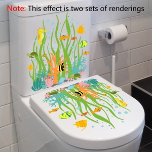 Detail of marine life toilet stickers with sea grass, fish, and turtle on white ceramic