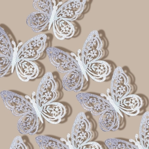 Pegatinas de mariposas huecas plateadas con corte láser y textura de brillo en 3D
