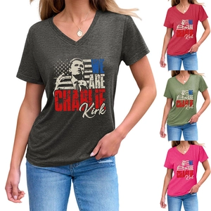 Detail view of V-neck Charlie Kirk portrait T-shirts in charcoal, red, green and pink