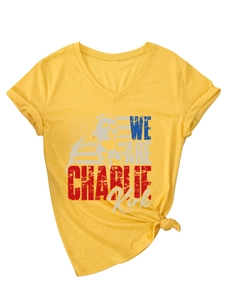 Detail of yellow V-neck t-shirt with Charlie Kirk graphic print and side knot style