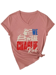 Detail of V-neck mauve T-shirt featuring a Charlie Kirk graphic and American flag print