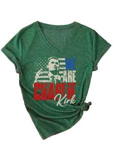 Detail of V-neck dark green T-shirt with Charlie Kirk print and knotted hem detail