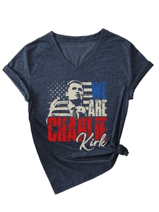 Detail of V-neck T-shirt showing Charlie Kirk portrait print and navy blue cotton fabric