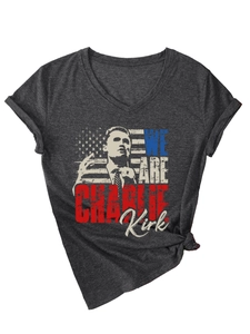 Detail of V-neck dark gray t-shirt featuring Charlie Kirk print and knotted hem