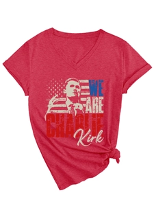 Detail of red V-neck T-shirt showing WE ARE CHARLIE KIRK print and knotted hem design