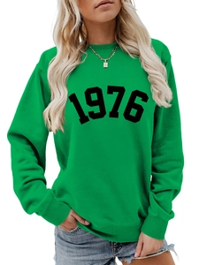 Detail of green sweatshirt with vintage 1976 print and ribbed knit cuffs and collar