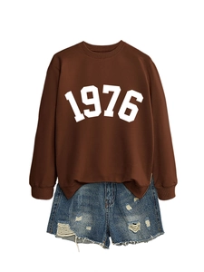 Detail of dark brown sweatshirt with 1976 print and distressed denim shorts