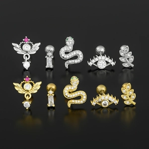 Set of surgical steel stud earrings featuring heart, snake, and gem designs in gold and silver