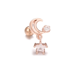 Detail of rose gold moon and star cartilage stud with zircon inlay and screw ball back
