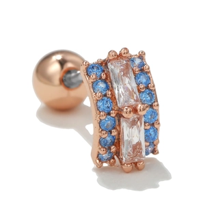 Detail of rose gold moon cartilage stud with blue and clear zircon and screw ball back