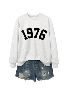 Detailed close-up of 1976 printed sweatshirt fabric texture and vintage numeric design