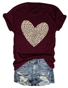 Flat lay of wine red leopard heart T-shirt paired with distressed blue denim shorts
