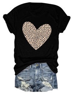 Detail of black cotton T-shirt featuring a large leopard print heart and distressed denim shorts