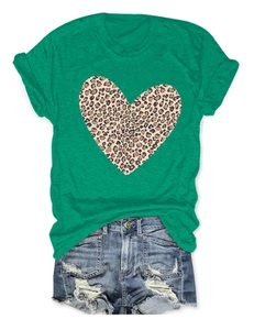 Detail of green women's T-shirt with leopard print heart and distressed denim shorts