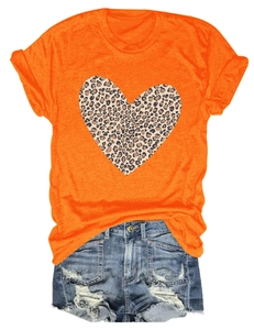 Detail view of orange T-shirt with leopard print heart and distressed denim shorts