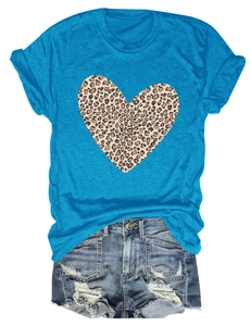 Detail of teal t-shirt featuring leopard print heart pattern and distressed denim shorts