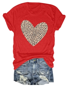 Flat lay of women's red crewneck tee with leopard heart print and distressed denim shorts