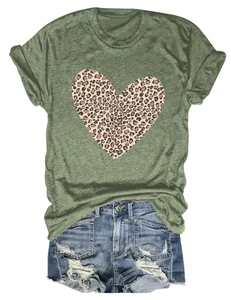 Detail of green T-shirt with leopard heart print and ripped denim shorts on white background