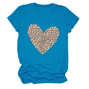 Detailed close-up of a leopard print heart pattern on a bright blue short sleeve t-shirt