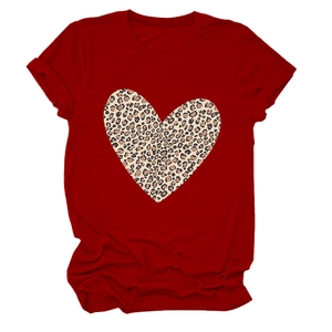 Detailed view of red t-shirt fabric featuring a large leopard print heart pattern