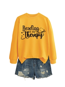 Detail of Reading is my Therapy printed text on yellow long sleeve crewneck sweatshirt