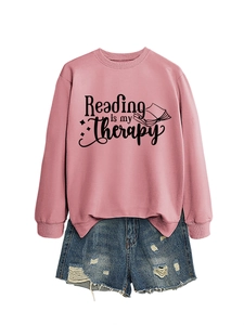 Detail of pink 'Reading is my therapy' sweatshirt with distressed blue denim shorts