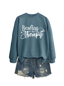 Detail of blue cotton sweatshirt with Reading is my Therapy print and denim shorts