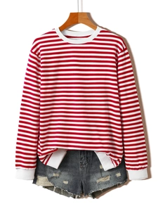 Detail of red and white striped sweatshirt with ribbed cuffs and distressed denim shorts