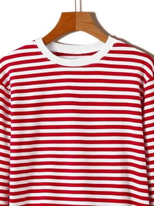 Close-up of red and white striped long sleeve sweatshirt with a white ribbed crewneck