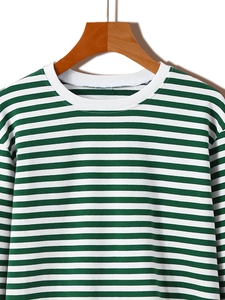 Detail of green and white striped long sleeve sweatshirt with ribbed crew neck design