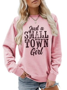 Detail of pink crewneck sweatshirt with Just a SMALL TOWN Girl print and ribbed cuffs