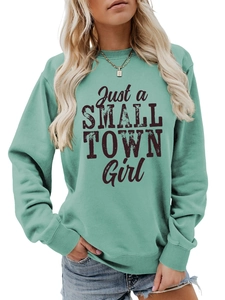 Detail of mint green long sleeve sweatshirt with Just a SMALL TOWN Girl black lettering