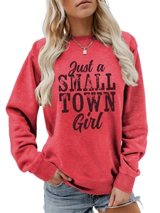 Close-up of red crewneck sweatshirt featuring vintage Just a SMALL TOWN Girl print