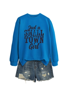 Close-up of Just a SMALL TOWN Girl print on blue sweatshirt with denim shorts