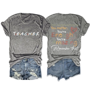 Detail of grey teacher t-shirt showing front logo and back motivational student quotes