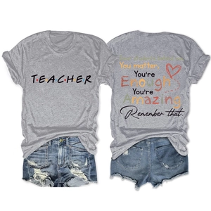 Detail of teacher slogan print on grey cotton t-shirt with ripped denim shorts