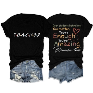 Detail of black teacher t-shirt featuring rainbow dots text and back student message