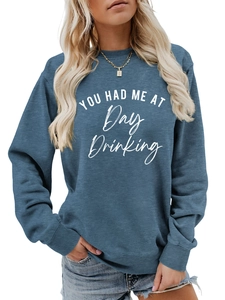 Close-up of the ribbed crew neck and slogan print on this hazy blue women sweater
