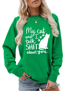Detail of funny cat quote and paw prints on green casual crewneck sweatshirt