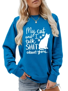 Detail of blue crewneck sweatshirt with cat silhouette and white slogan print