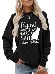 Detail view of 'My cat and I talk shit about you' text and cat silhouette on black sweatshirt
