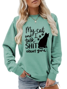 Detail of mint green sweatshirt with My cat and I talk shit black cat graphic print