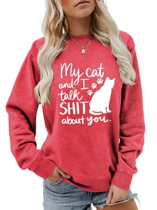 Detail of red crewneck sweatshirt featuring white cat silhouette and humorous text design