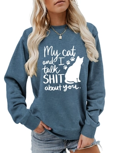 Detail of blue crewneck sweatshirt featuring white cat silhouette and humorous text print