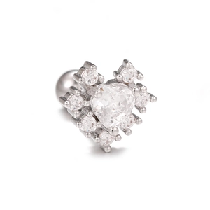 Close-up of heart-shaped zircon ear stud with silver metal and micro-pave setting details