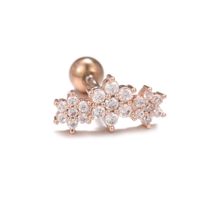 Detailed macro shot of rose gold flower stud earring with micro-pave white zircon stones