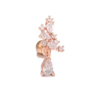 Macro detail of rose gold cartilage earring with zircon flower cluster and drop pendant